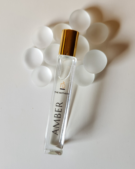 Amber Perfume Oil -10ml Roller Bottle on white stones  | The Nothern