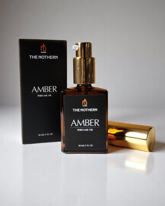 The Nothern Amber Perfume Oil bottle with pump top and packaging on a neutral background