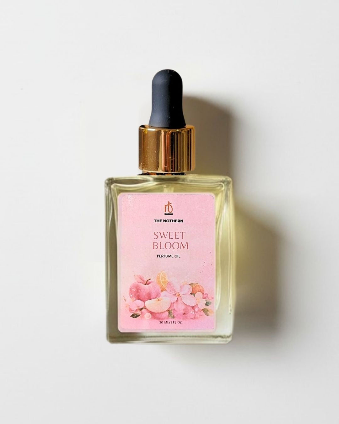 Sweet Bloom Perfume oil bottle with a dropper on a light background | The Nothern
