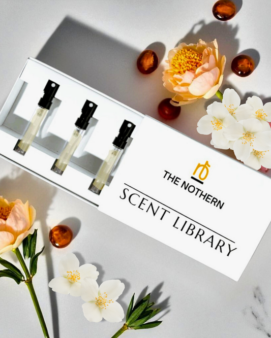 The Northern Scent Library perfume sample set with flowers on a light background